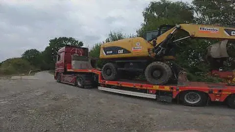 Транспортировка колесного экскаватора CATERPILLAR M318D