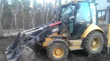 Погрузчик экскаватор CAT 428E корчевка пня